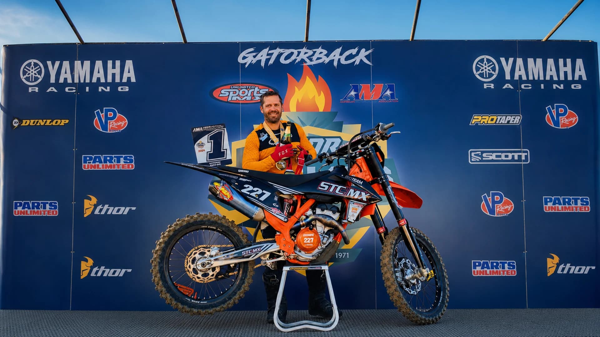 Mike Stevenson with his motorcycle at the podium